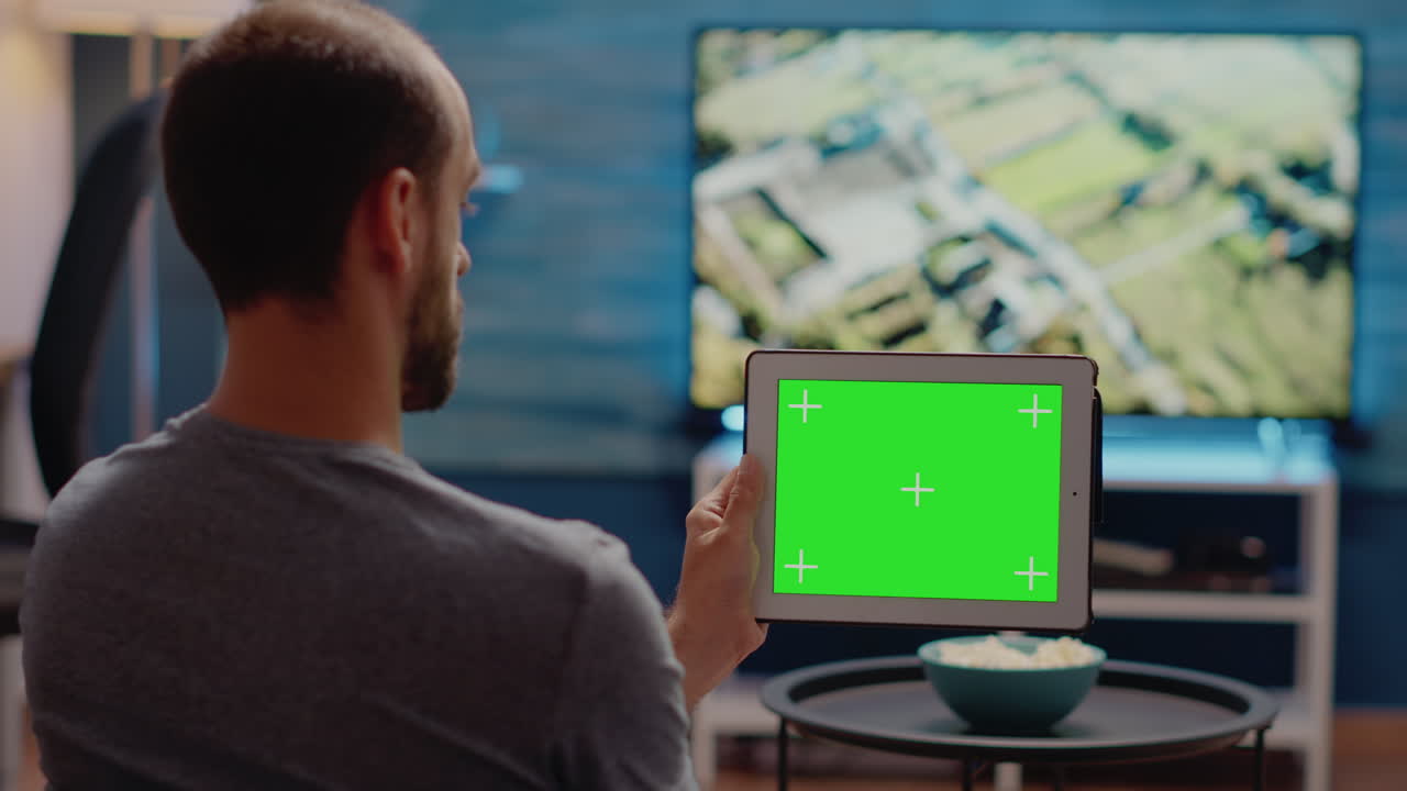 Person using modern tablet horizontally for green screen