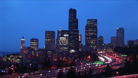 traffic creates solid streams of light as cars move along a multilane seattle expressway