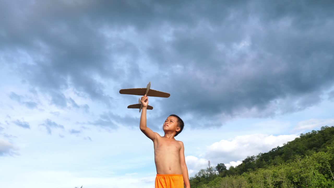 Child playing with a paper airplane