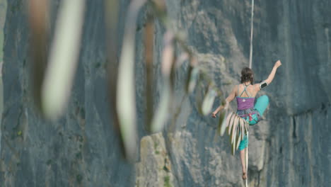 athlete on slack line high line extreme sport over cliff tiger rope walking