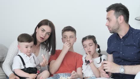 family watching tv with popcorn