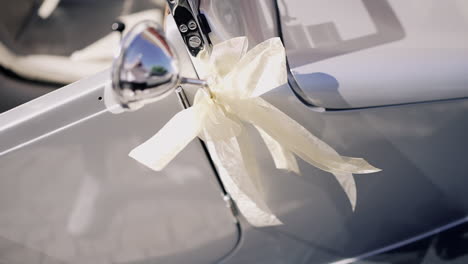 classic car adorned with decorative ribbon