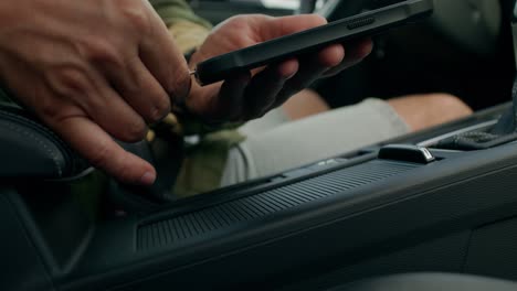 person charging phone in a car