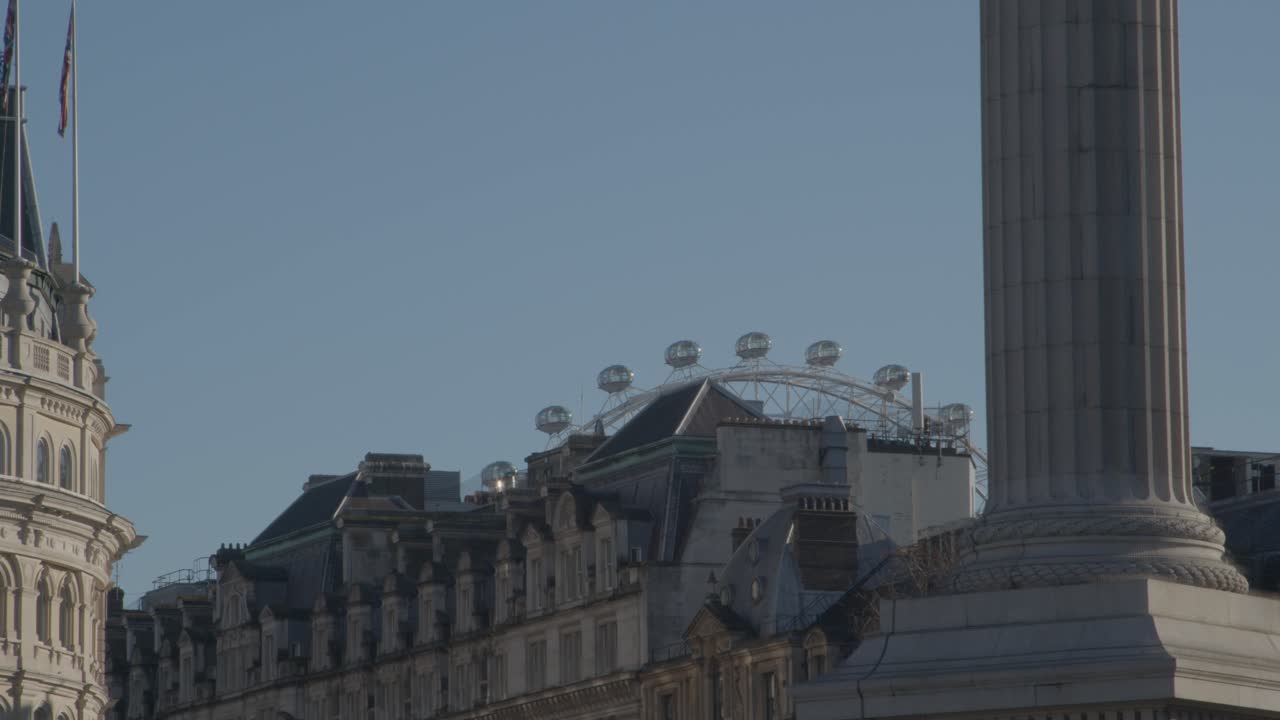 The London Eye towering over the city buildings.