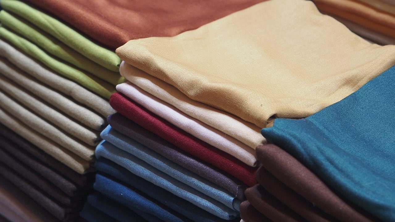 Close-up of Neatly Folded Colorful Fabrics Stacked in a Store