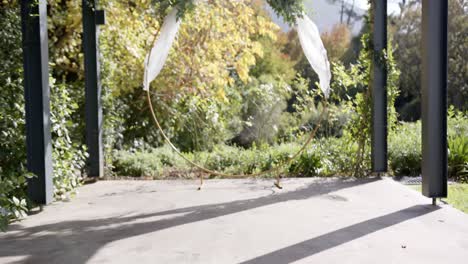 general view of wedding arch with decorations and flowers in sunny garden, copy space, slow motion