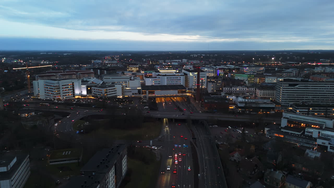Aerial tracking shot in front of the Kupittaa railway station, evening in Turku
