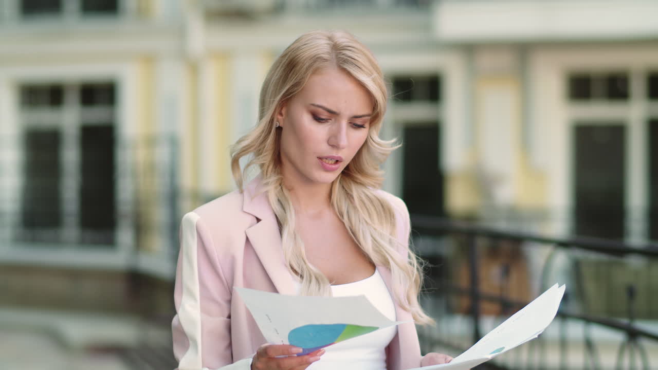 Business woman reading documents at street. Businesswoman working with papers