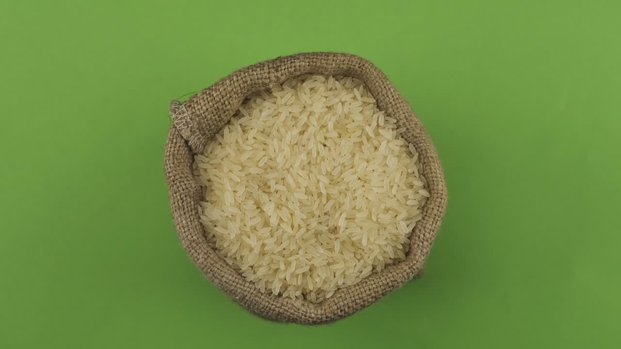 Rotation of a full sack of rice grain. Top view. Isolated
