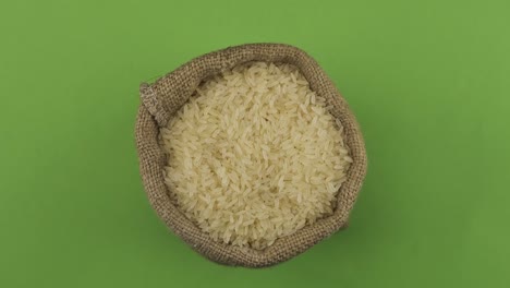 rotation of a full sack of rice grain. top view. isolated