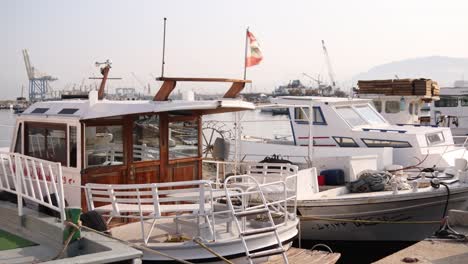 rows-of-boats-and-yachts-in-mediterranean-harbor-with-flag-waving-in-Tripoli,-Northern-Lebanon