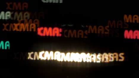 beautiful xmas text shaped bokeh from moving car and traffic lights at the evening, christmas, winter or holiday background concept, copyspace