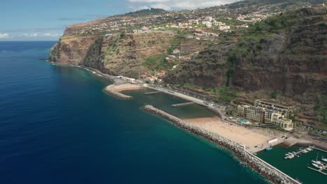 touristic shore on volcanic island with man made sandy calheta beach