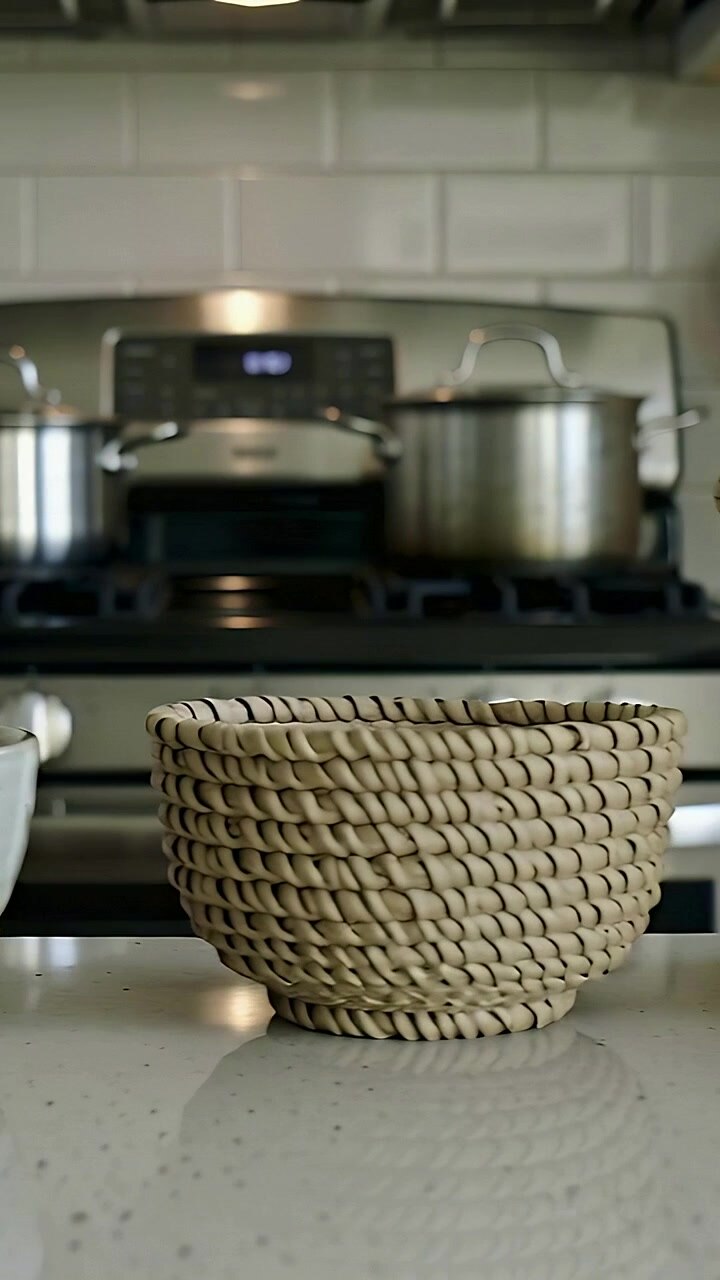 Vertical video: Placing from left, woman in mint top arranging bowls on counter to serve