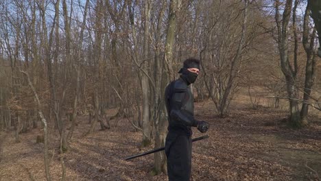 a ninja dressed in black stealth gear moves through a misty forest, gripping his sword. perfect for action-packed content, martial arts visuals, and cinematic storytelling.