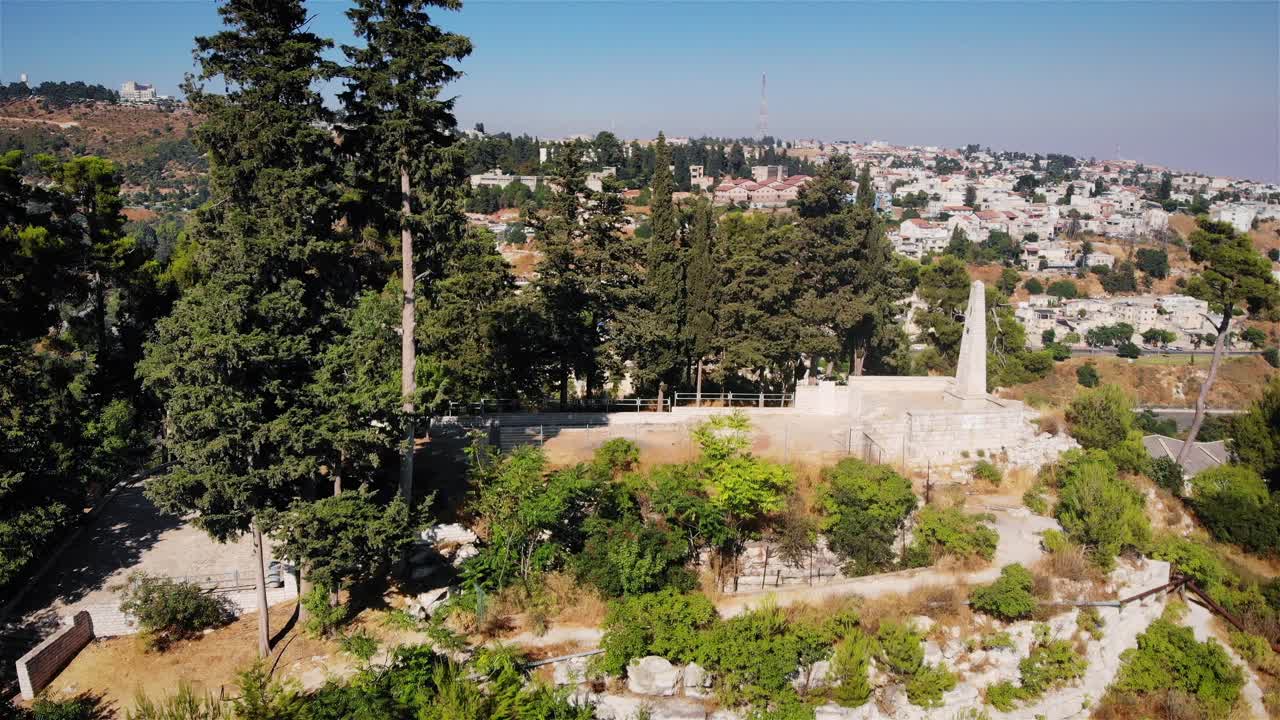 Aerial View of a Monument and Cityscape from a Hillside Park