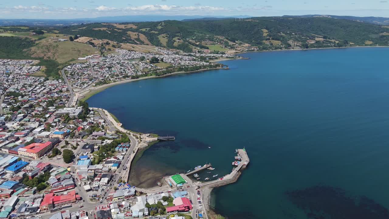 Explore the aerial perspective of Ancud city and its surrounding picturesque coastline. rising shot
