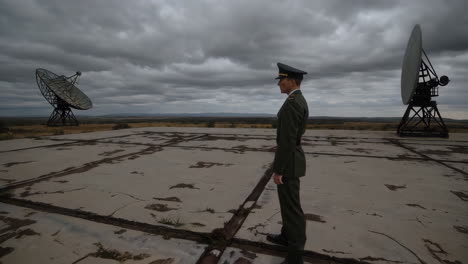 military officer at an abandoned satellite dish station