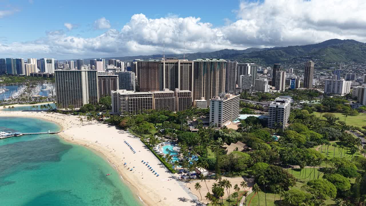 Drone Shot of Honolulu, Hawaii USA, Waikiki Beach, Beachfront Park and Hotels and Condominium Towers