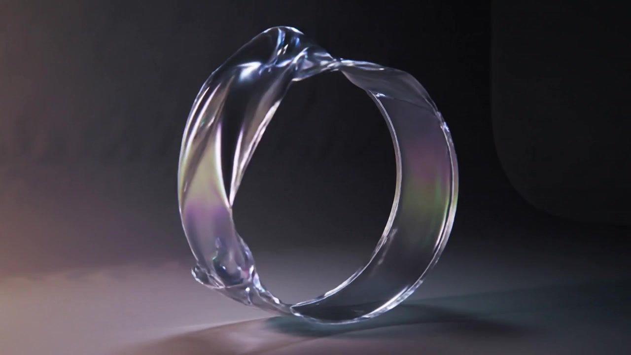 Rotating glass ribbon loop folding on tabletop, lights revealing purple-blue iridescent highlights