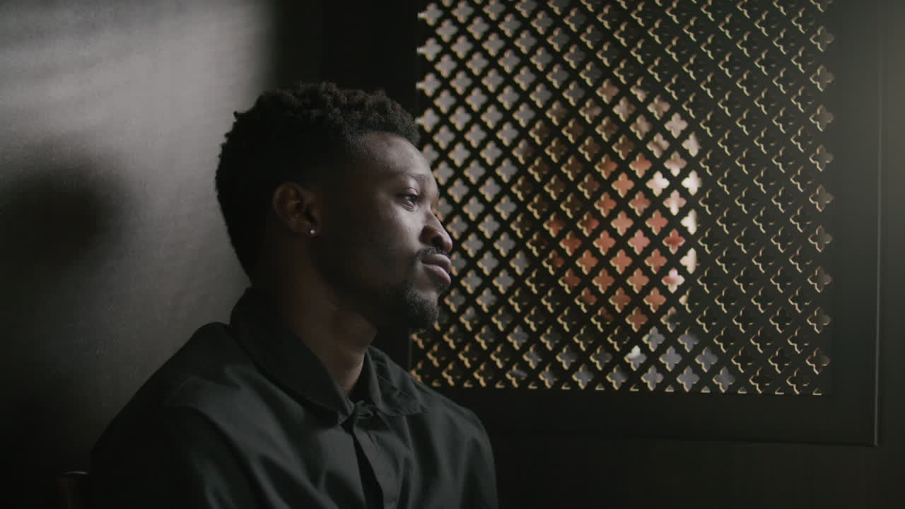 Young Black Parishioner Talking with Priest in Confessional Booth