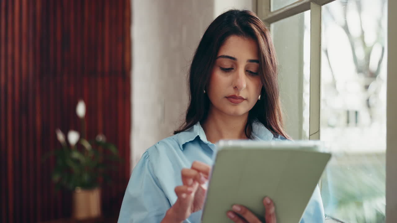 Woman Daydreaming with Tablet by the Window