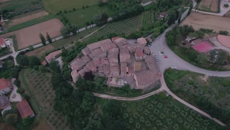 aerial drone shot fly over and tilt down onto medieval italian village in umbria, italy
