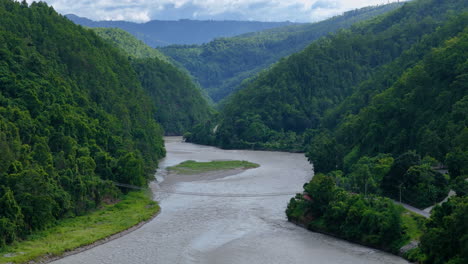 beautiful landscape drone shot of nepal with lush green hills and the bhotekoshi river flooding during monsoon