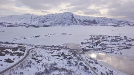 Aerial-follow-of-a-truck-on-a-road-in-Lofoten-Islands,-Norway,-during-winter