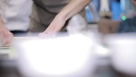 prepare japanese sushi rolls. woman chef ready to prepare japanese sushi rolls, with principal ingredients