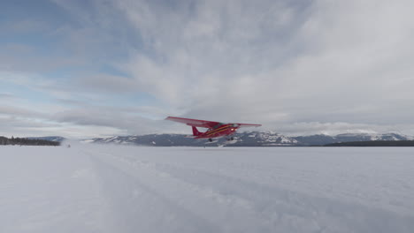 shot of a plane taking off from a frozen lake in winter