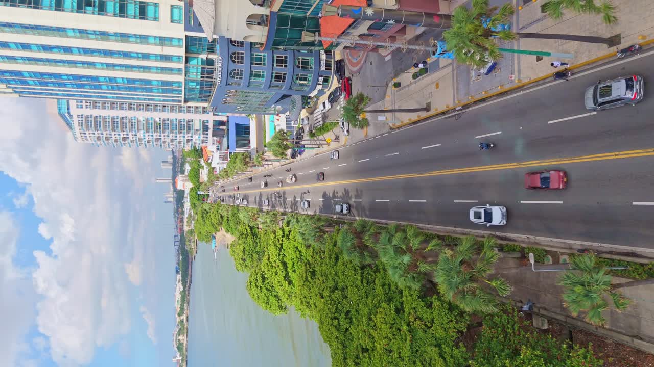 Drone flying over George Washington Avenue, Malecon of Santo Domingo in Dominican Republic. Aerial forward and Vertical format