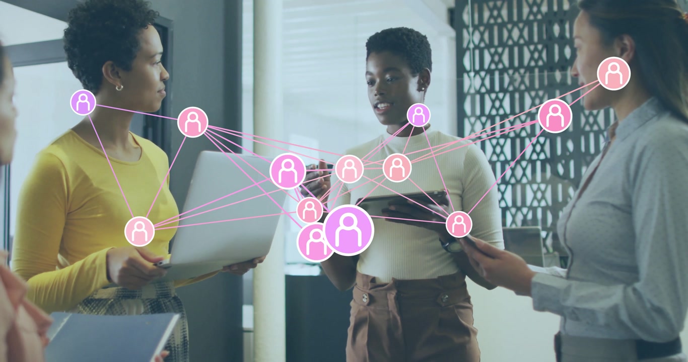 Business team speaking around devices generating network overlay pulsing user nodes for insights