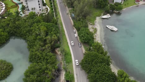 a stunning, sun-drenched aerial flyover of the exclusive freeport community in montego bay, the perfect depiction of a luxury tropical lifestyle, wealth, and idyllic travel destinations