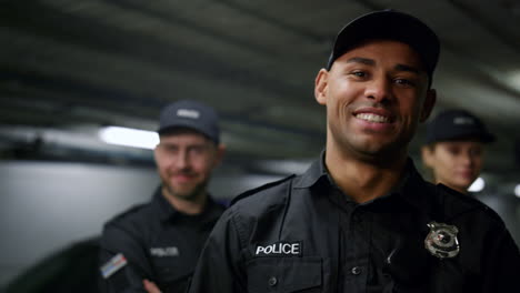 policeman smiling at camera. positive cop in uniform posing at camera