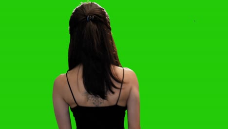 pretty petite girl adjusts hair and turns around and walks away on green screen