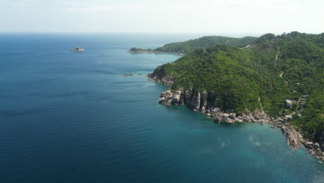 forested mountains surrounded by seascapes on the island of koh tao in surat thani, thailand