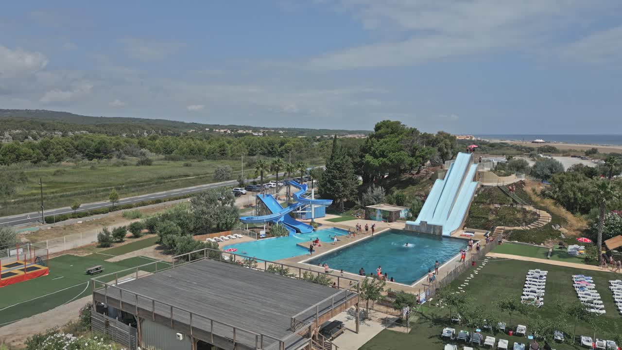 Tourists enjoying their summer vacation splash and laugh at an aquajet waterpark near narbonne, creating joyful memories in the sun with family and friends