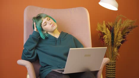 tired young woman at laptop.