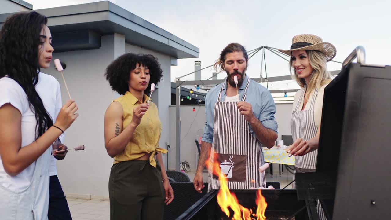 Friends roasting marshmallows on a rooftop barbecue