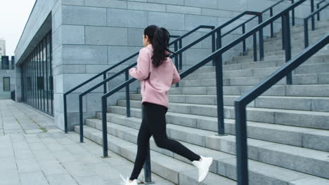 sporty girl running downstairs