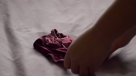 men use their hands to fold men's underwear to keep it organized and easy to store and use