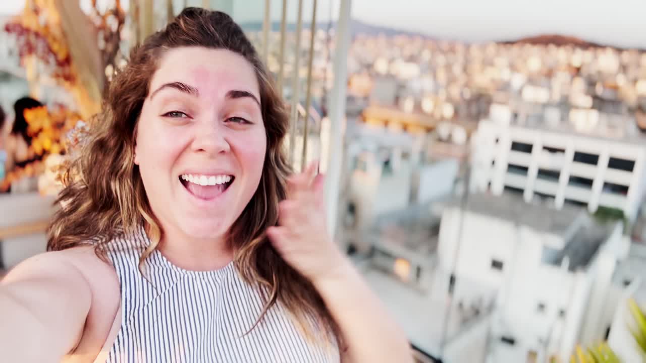 Vlogger Woman Pointing at Athens Skyline from Rooftop