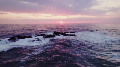 sunrise over the ocean with rocks