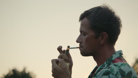 man smoking at sunset