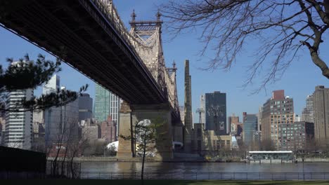 under queensboro bridge with bright blue skies