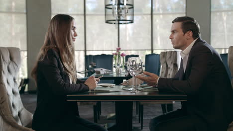 business man and woman talking in restaurant. businessman and businesswoman