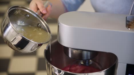 pouring liquid ingredients into stand mixer