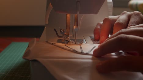 Side-view-of-slow-motion-needle-movement-of-sewing-machine-pulling-fabric-through