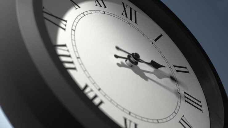 Latin Clock Face on Light Blue Wall in Time Lapse